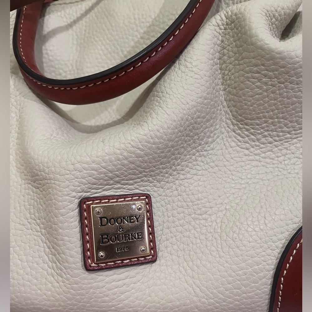 Dooney&Bourke Crossbody bucket bag. Light beige, off white in color